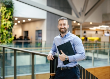 jordan holding laptop at fonterra centre